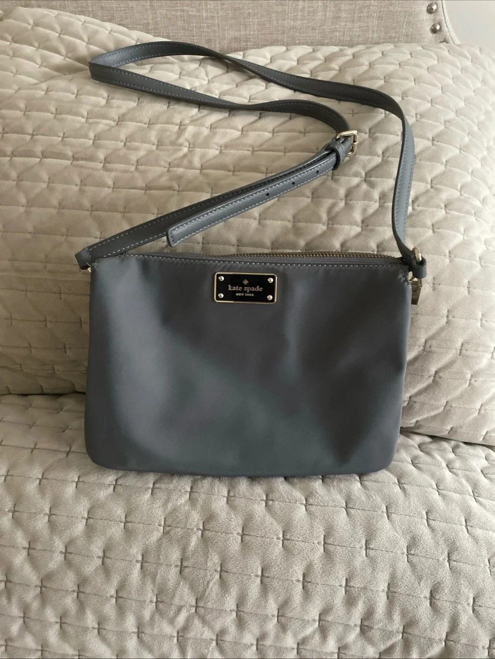 kate spade gray nylon crossbody with gold logo plaque